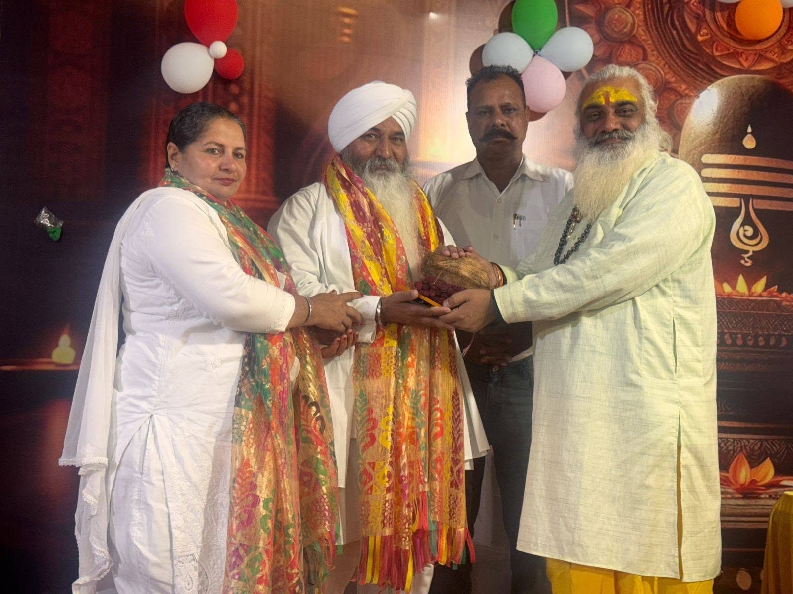 Guests being honoured on stage at a Sanstha programme