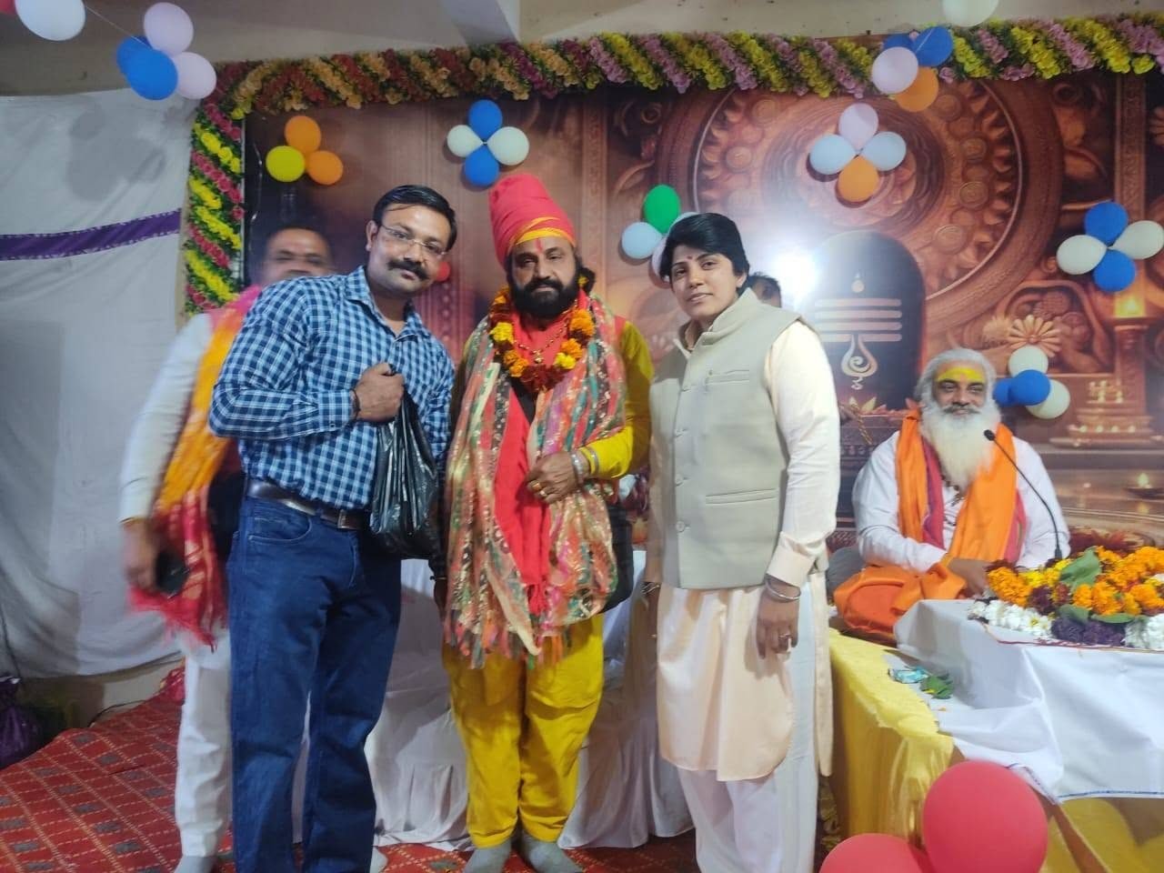 Participants at a decorated pandal during a festival programme