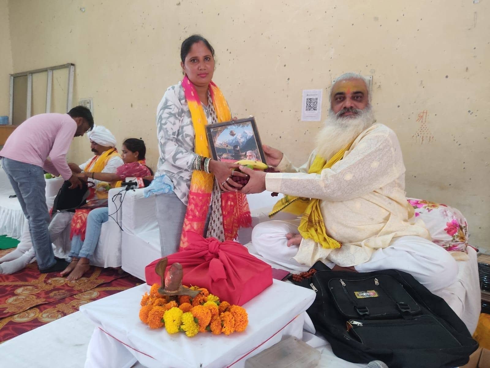 A woman member being honoured at a Sanstha programme