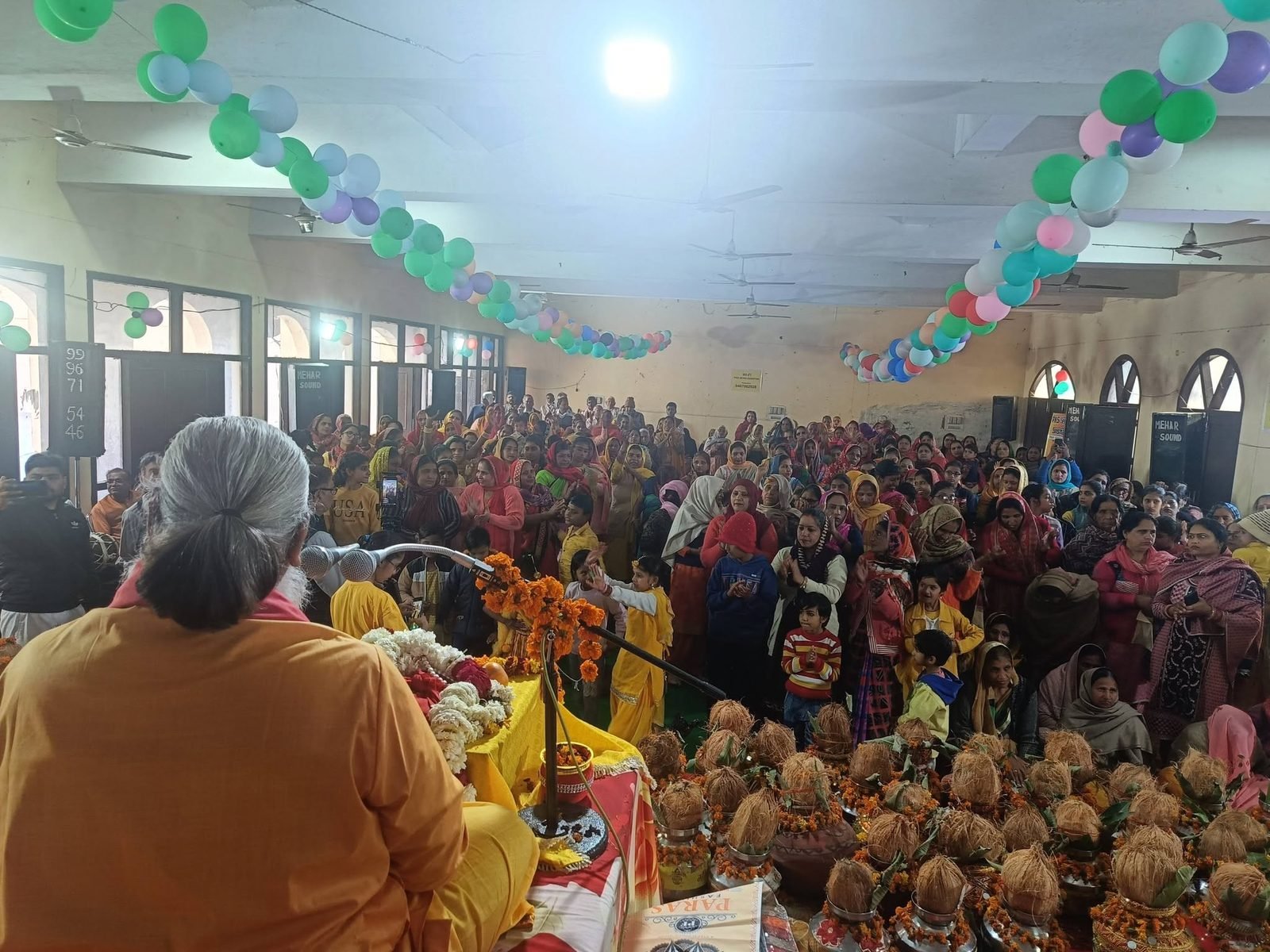Addressing the gathering from the stage at a Sanstha programme