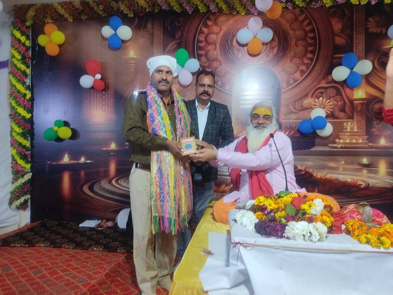 A police officer being honoured on stage at a Sanstha programme